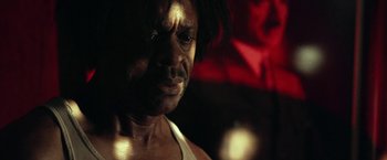 Movie still from “31” (2016), directed by Rob Zombie – A man's face in a dark room; Close Up shot, Low angle