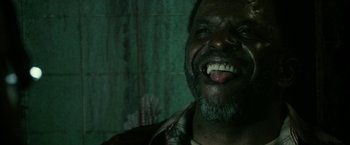Movie still from “31” (2016), directed by Rob Zombie – A person smiling with his mouth wide open; Close Up shot, Low angle