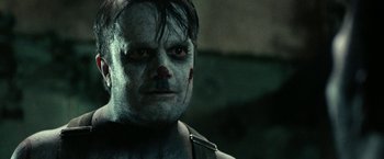 Movie still from “31” (2016), directed by Rob Zombie – A person with a clown make up on; Close Up shot, Over the shoulder angle