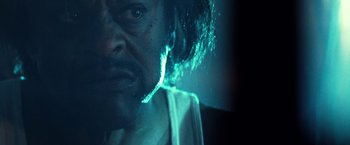 Movie still from “31” (2016), directed by Rob Zombie – A man's face in a dark room; Extreme Close Up shot, Low angle