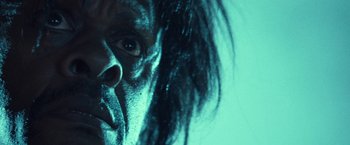 Movie still from “31” (2016), directed by Rob Zombie – The face of a man with long black hair; Extreme Close Up shot, Low angle