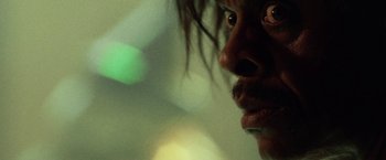 Movie still from “31” (2016), directed by Rob Zombie – A man's face in a room with green lights; Extreme Close Up shot, Low angle