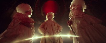 Movie still from “31” (2016), directed by Rob Zombie – A group of men in fur coats standing next to each other in a room; Wide shot, Low angle