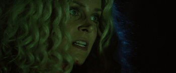 Movie still from “31” (2016), directed by Rob Zombie – A woman's face in the dark; Close Up shot, Low angle