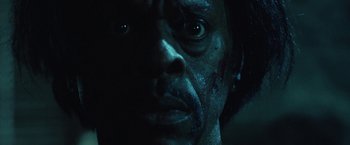 Movie still from “31” (2016), directed by Rob Zombie – A man's face in the dark; Extreme Close Up shot, Low angle