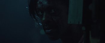 Movie still from “31” (2016), directed by Rob Zombie – A person in a dark room; Close Up shot, High angle
