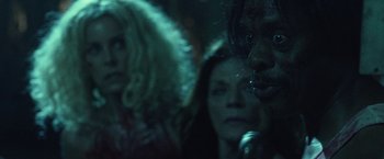 Movie still from “31” (2016), directed by Rob Zombie – A group of people standing next to each other on a stage; Close Up shot, Over the shoulder angle