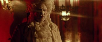 Movie still from “31” (2016), directed by Rob Zombie – A man in a white wig and a white shirt; Medium shot, Low angle