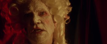 Movie still from “31” (2016), directed by Rob Zombie – An old man with a wig and a white beard; Extreme Close Up shot, Low angle