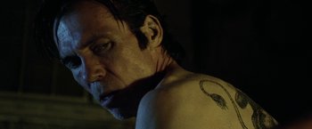 Movie still from “31” (2016), directed by Rob Zombie – A person with a tattoo; Close Up shot, Low angle