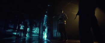 Movie still from “31” (2016), directed by Rob Zombie – A group of people standing in a room; Wide shot, Low angle