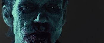 Movie still from “31” (2016), directed by Rob Zombie – A man's face with blood on his mouth; Extreme Close Up shot, Low angle