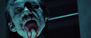 Movie still from “31” (2016), directed by Rob Zombie – A person's face covered in blood; Close Up shot, Low angle