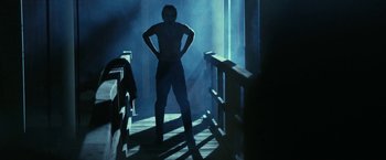 Movie still from “31” (2016), directed by Rob Zombie – A man standing on a wooden deck in the dark; Wide shot, Low angle