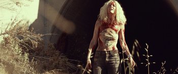 Movie still from “31” (2016), directed by Rob Zombie – A man with long blonde hair and a lot of blood on his body; Medium shot, Low angle