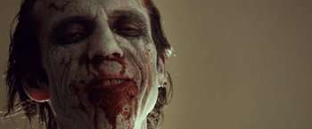 Movie still from “31” (2016), directed by Rob Zombie – A man's face covered in blood; Extreme Close Up shot, Low angle