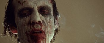 Movie still from “31” (2016), directed by Rob Zombie – A man's face covered in blood; Extreme Close Up shot, Low angle