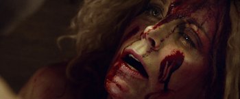Movie still from “31” (2016), directed by Rob Zombie – A person's face covered in blood; Extreme Close Up shot, Overhead angle