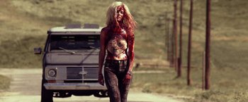 Movie still from “31” (2016), directed by Rob Zombie – A woman with blood all over her body; Wide shot, Low angle