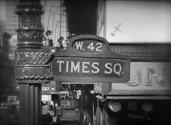 Movie still from “42nd Street” (1933), directed by Lloyd Bacon – A black and white photo of a street sign in times square; Extreme Close Up shot, High angle