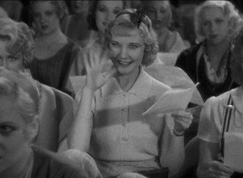 Movie still from “42nd Street” (1933), directed by Lloyd Bacon – An old photo of a woman holding a piece of paper; Medium shot, High angle