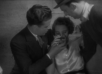 Movie still from “42nd Street” (1933), directed by Lloyd Bacon – A man and a woman looking at a cell phone while another man looks on; Medium shot, High angle