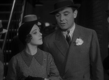 Movie still from “42nd Street” (1933), directed by Lloyd Bacon – A man and a woman standing next to each other; Medium shot, Low angle