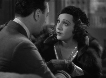 Movie still from “42nd Street” (1933), directed by Lloyd Bacon – A man and a woman are talking to each other; Close Up shot, Over the shoulder angle