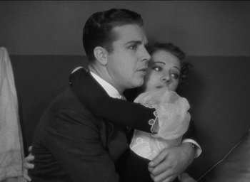 Movie still from “42nd Street” (1933), directed by Lloyd Bacon – A man holding a young girl in his arms; Medium shot, High angle