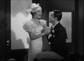 Movie still from “42nd Street” (1933), directed by Lloyd Bacon – A man and a woman are holding hands; Medium shot, High angle