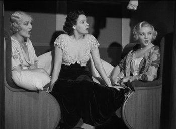 Movie still from “42nd Street” (1933), directed by Lloyd Bacon – A group of women sitting on top of couches in a room; Medium shot, High angle