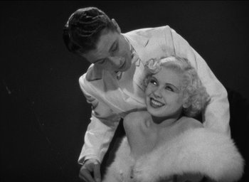 Movie still from “42nd Street” (1933), directed by Lloyd Bacon – A man and a woman posing for a picture; Medium shot, Low angle