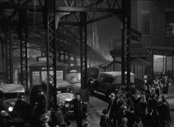 Movie still from “42nd Street” (1933), directed by Lloyd Bacon – A black - and - white photo of a train station; Extreme Wide shot, High angle