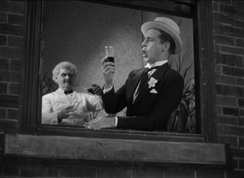 Movie still from “42nd Street” (1933), directed by Lloyd Bacon – An older woman and a young man are drinking wine; Medium shot, Low angle