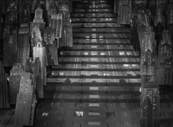 Movie still from “42nd Street” (1933), directed by Lloyd Bacon – An aerial view of a city at night with lights; Extreme Wide shot, High angle