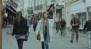 Movie still from “45 Years” (2015), directed by Andrew Haigh – A woman walking down the street with a purse in her hand; Wide shot, Over the shoulder angle