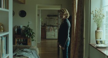 Movie still from “45 Years” (2015), directed by Andrew Haigh – A woman standing in a room looking out a window; Wide shot, Low angle