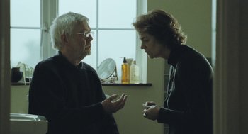 Movie still from “45 Years” (2015), directed by Andrew Haigh – A man and a woman talking in front of a window; Medium shot, Over the shoulder angle