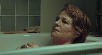 Movie still from “45 Years” (2015), directed by Andrew Haigh – An older woman sitting in a bath tub; Close Up shot, Low angle