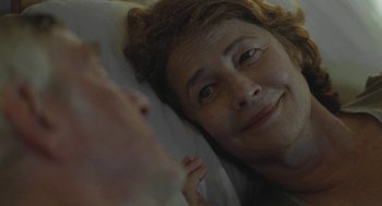 Movie still from “45 Years” (2015), directed by Andrew Haigh – A person laying in a bed smiling; Close Up shot, Over the shoulder angle