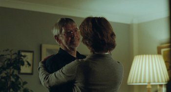 Movie still from “45 Years” (2015), directed by Andrew Haigh – An older man and a younger woman dancing in a living room; Medium shot, Over the shoulder angle