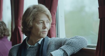 Movie still from “45 Years” (2015), directed by Andrew Haigh – An older woman sitting on a train looking out the window; Close Up shot, Over the shoulder angle