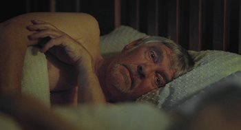 Movie still from “45 Years” (2015), directed by Andrew Haigh – An older man laying in a bed with his head resting on a pillow; Close Up shot, High angle