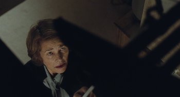 Movie still from “45 Years” (2015), directed by Andrew Haigh – An older woman holding a pen and looking at a mirror; Close Up shot, Low angle