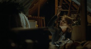 Movie still from “45 Years” (2015), directed by Andrew Haigh – A woman sitting at a table in a room; Medium shot, Low angle