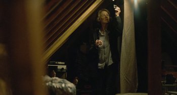 Movie still from “45 Years” (2015), directed by Andrew Haigh – An older man holding a cell phone in his hand; Medium shot, Low angle