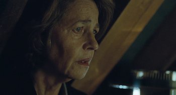 Movie still from “45 Years” (2015), directed by Andrew Haigh – An older woman looking into the distance with her eyes wide open; Close Up shot, Over the shoulder angle