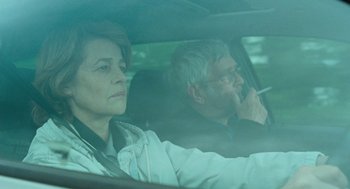 Movie still from “45 Years” (2015), directed by Andrew Haigh – A man and a woman sitting in the back of a car; Medium shot, Over the shoulder angle