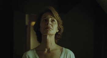 Movie still from “45 Years” (2015), directed by Andrew Haigh – An older woman looking up in a dark room; Close Up shot, Low angle