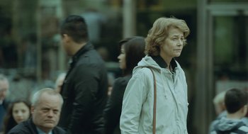 Movie still from “45 Years” (2015), directed by Andrew Haigh – A group of people walking down a street; Medium shot, Over the shoulder angle